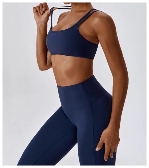 A woman in blue sports bra and leggings.