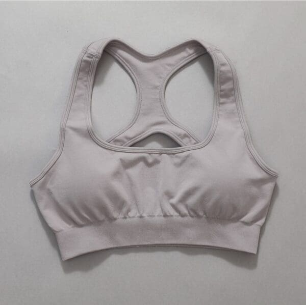 A white sports bra is shown on the wall.