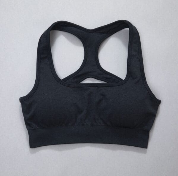 A black sports bra is shown on the wall.