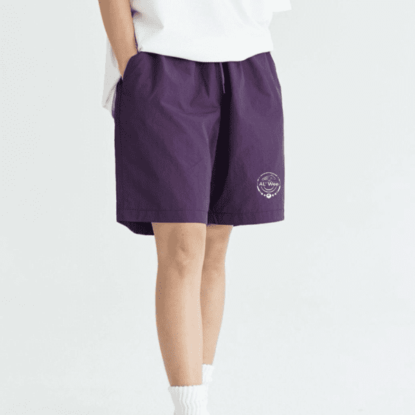 A person wearing purple shorts and white socks.