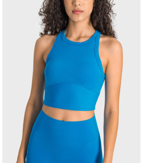 A woman wearing a blue crop top and skirt.