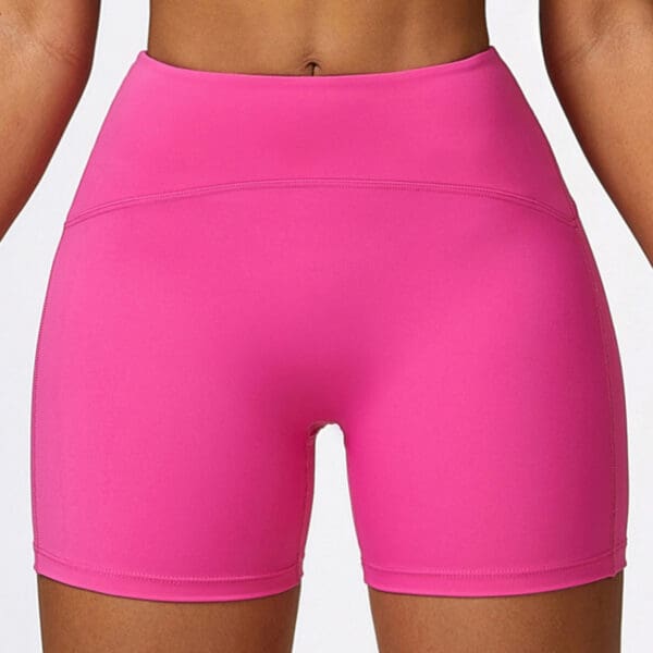 A close up of the back of a person wearing pink shorts.