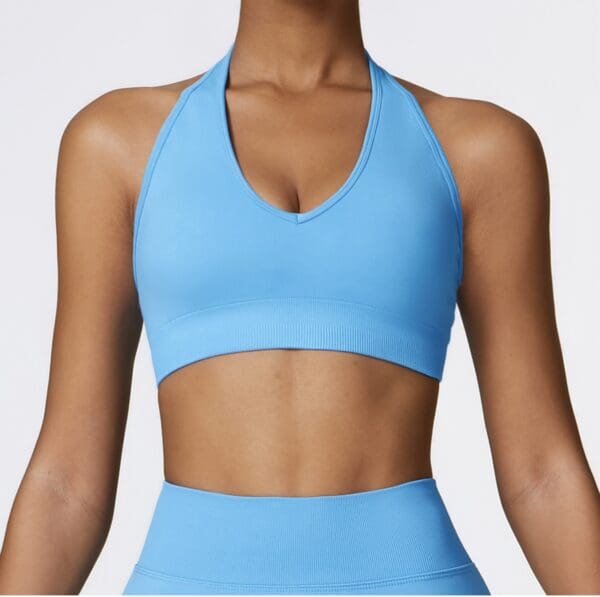 A close up of a person wearing a blue sports bra