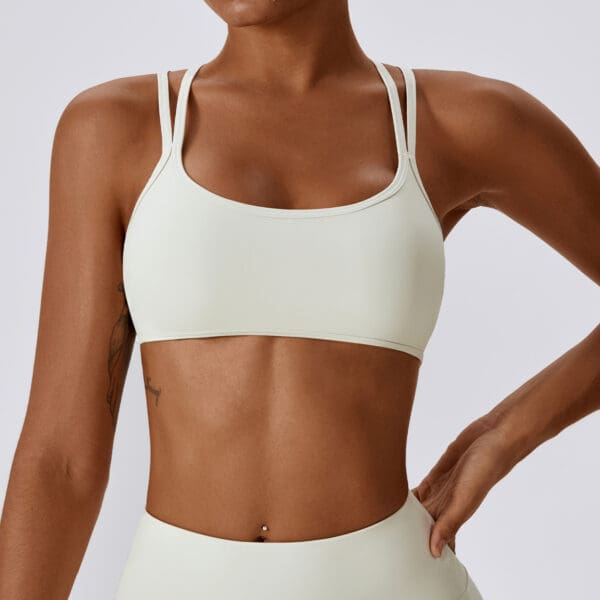 A woman in white sports bra and shorts.