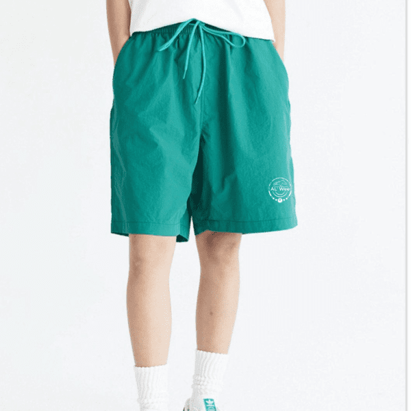 A person wearing green shorts and white socks.